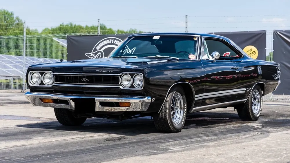 A vibrant red 1969 Plymouth GTX, showcasing its iconic muscle car design.