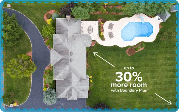An aerial view of a house and yard, with a subtle highlight around the property boundary indicating an invisible outdoor dog fence.