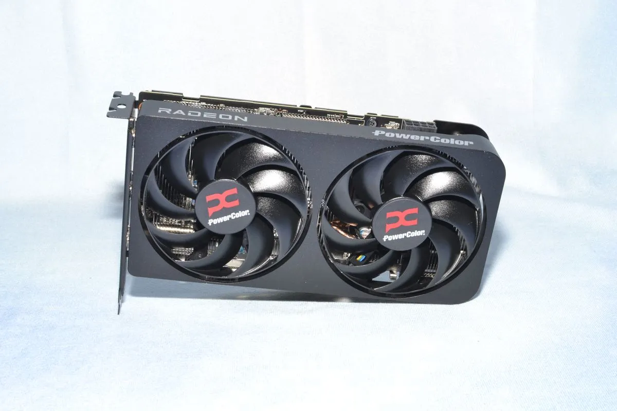 An AMD Radeon RX 9060 XT 16GB graphics card on a white background, highlighting its dual-fan cooler.