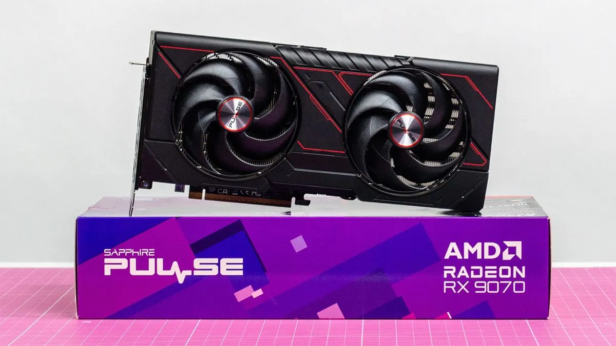 An AMD Radeon RX 9070 sitting on its retail packaging with its fans visible