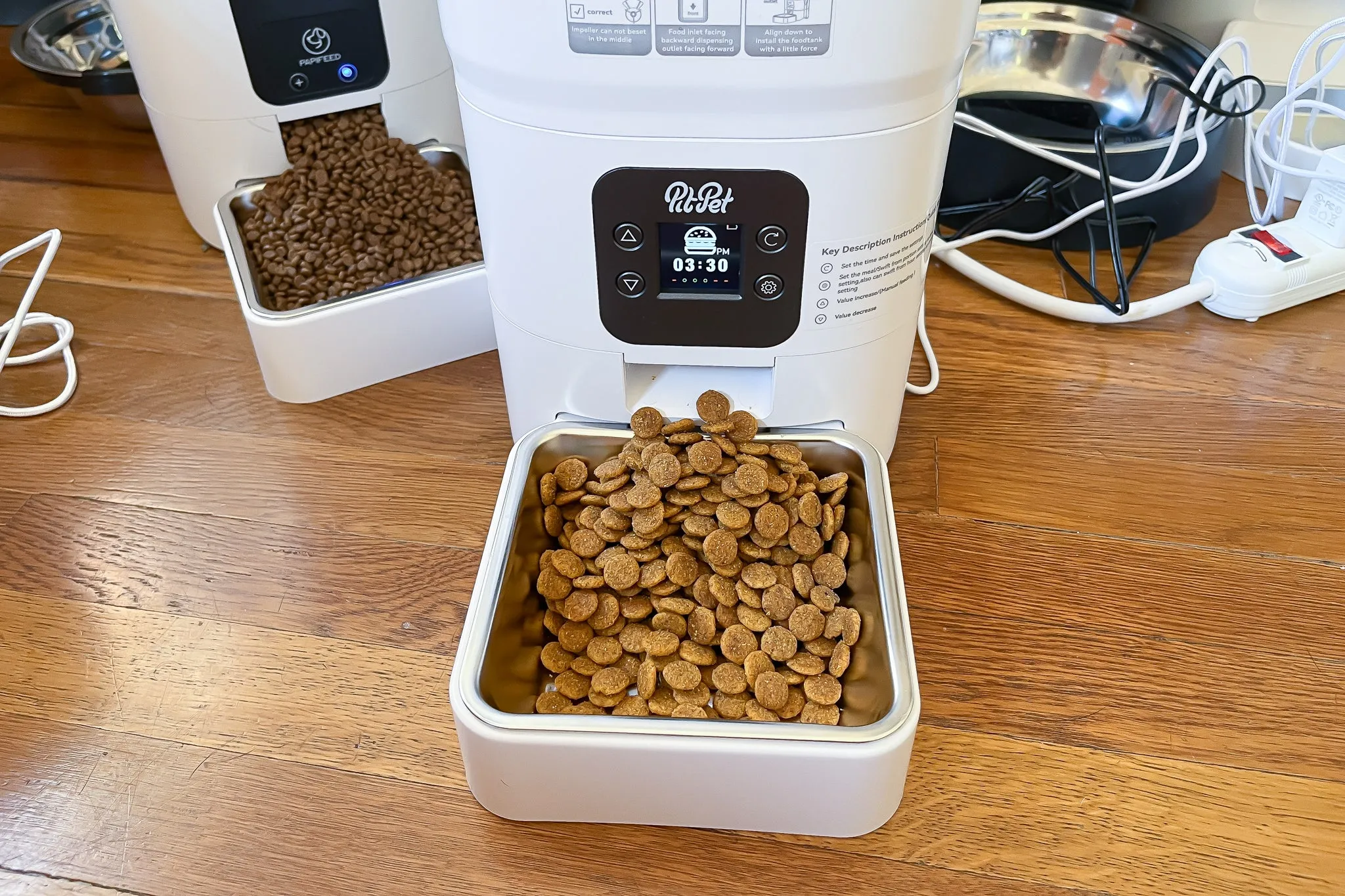 An automatic pet feeder filled with dry dog kibble, ready to dispense.
