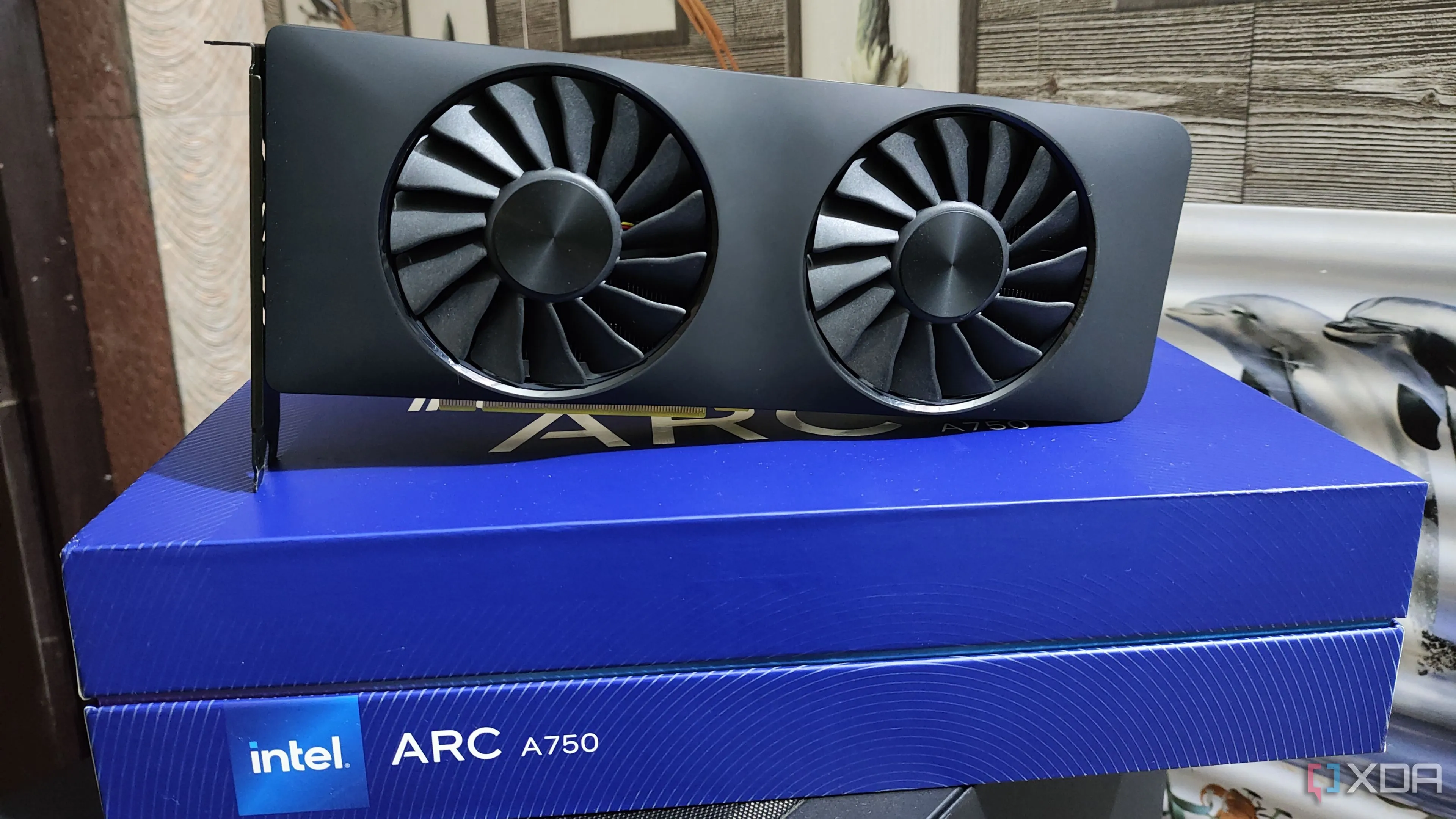 An Intel Arc A750 placed on top of its box, illustrating a new graphics card.