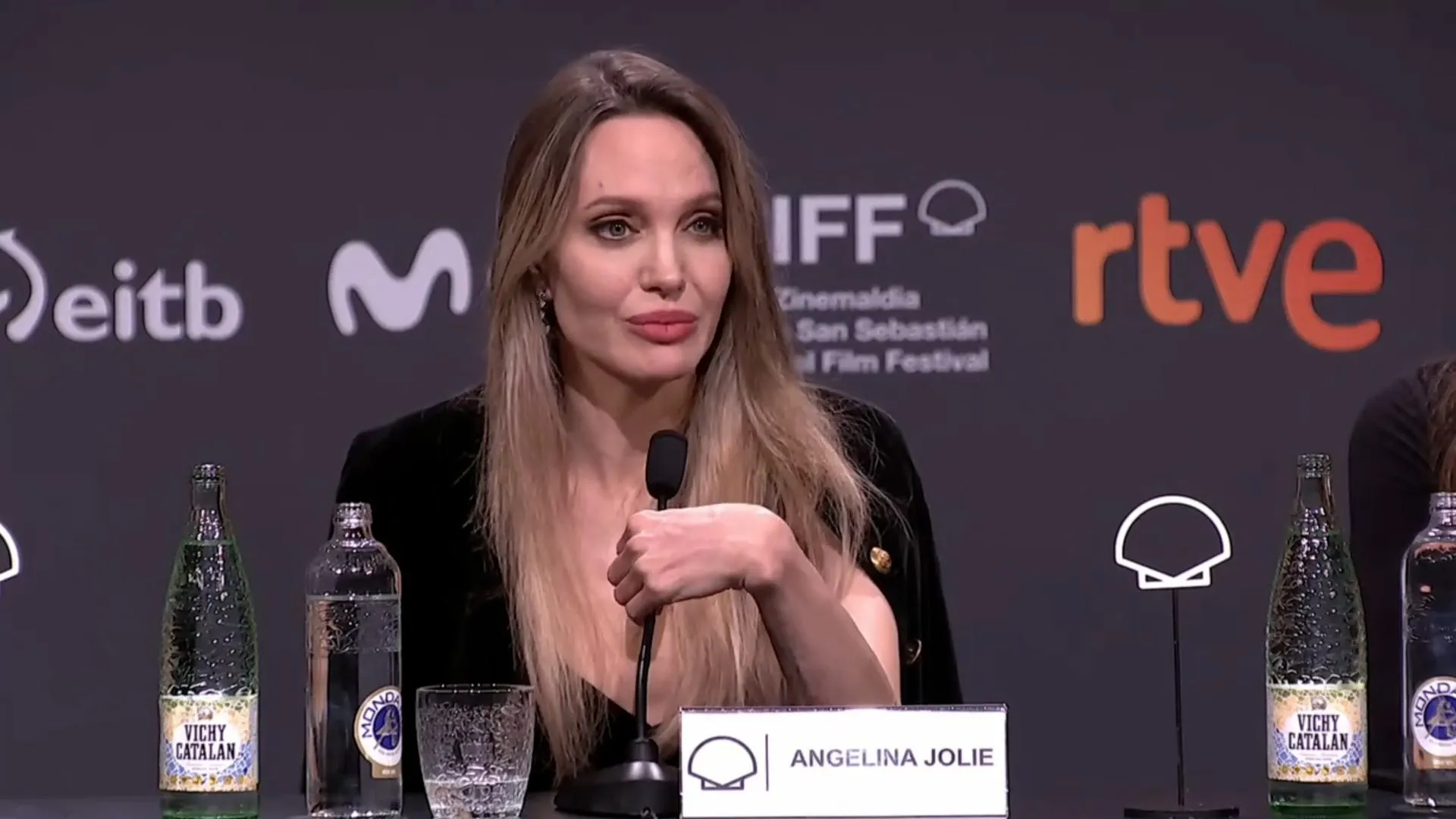 Angelina Jolie speaking at a press conference, expressing concern over free speech in the United States