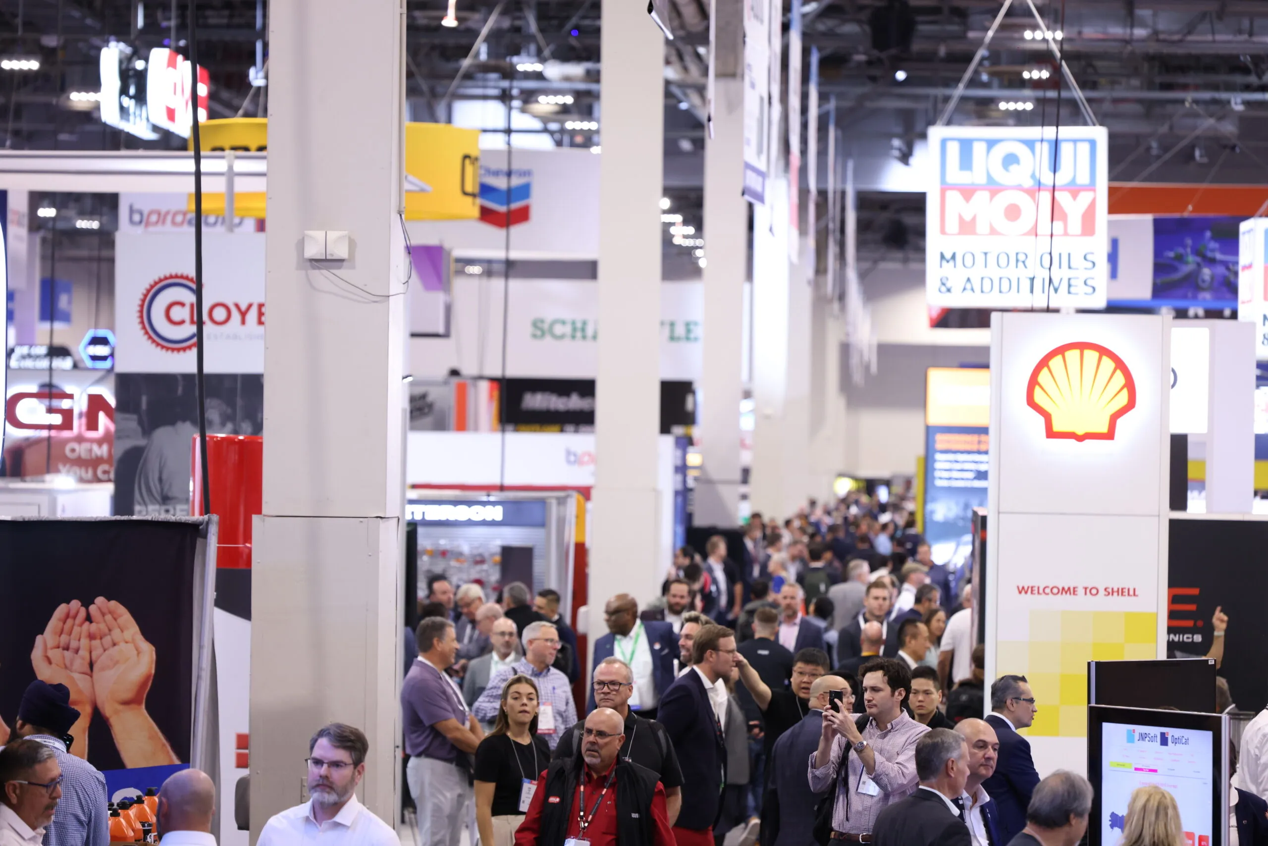 Attendees and exhibitors interacting at the AAPEX 2023 trade show