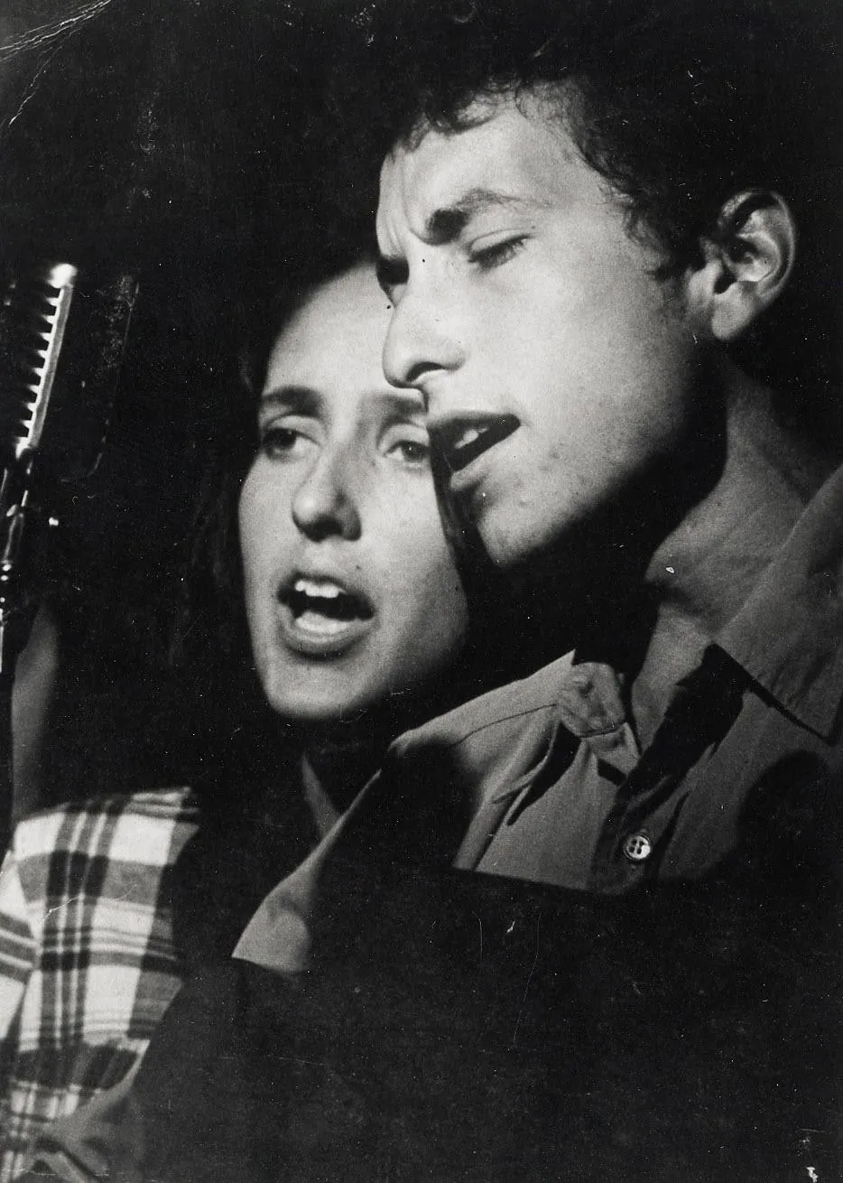 Bob Dylan and Joan Baez captivating an audience with a passionate duet on stage