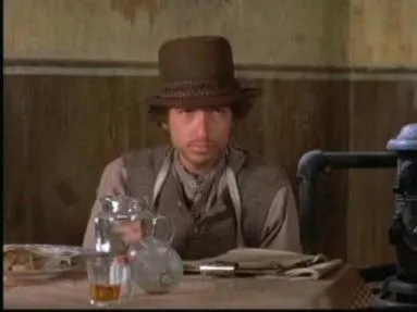 Bob Dylan as Alias, staring vacantly in a saloon scene from Pat Garrett and Billy the Kid.