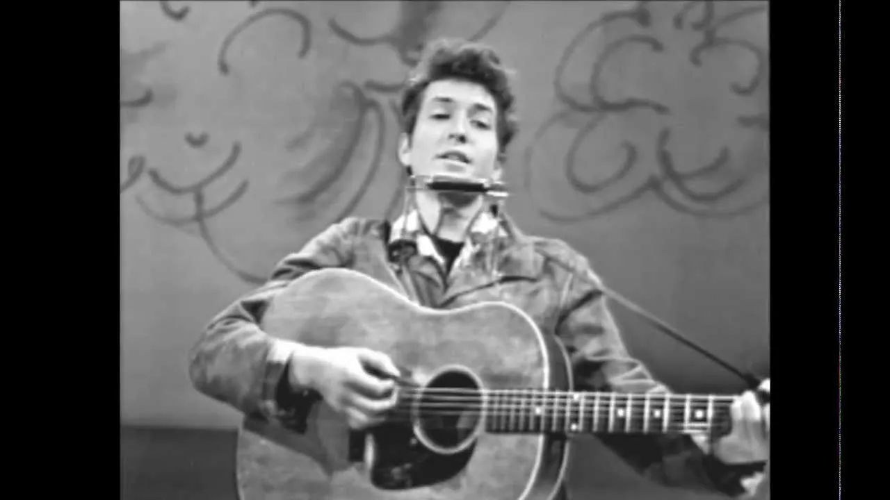 Bob Dylan performing "Like a Rolling Stone" live on stage
