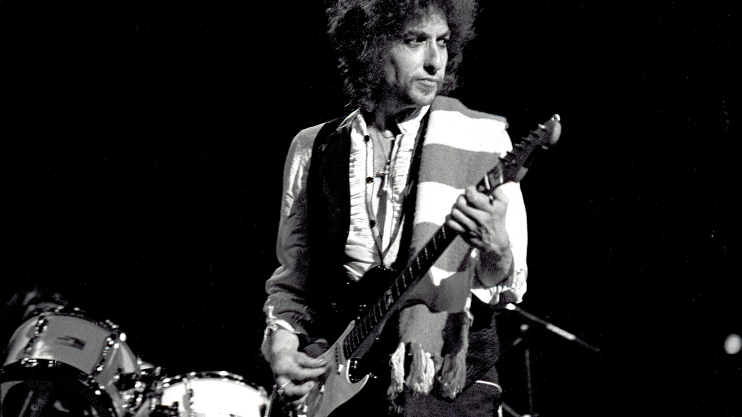 Bob Dylan performing live in Atlanta during his 1978 Budokan era tour, demonstrating a departure from his earlier performance styles.