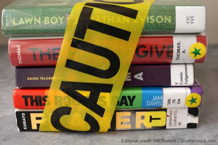 Bookshelves in a public library setting with diverse titles, emphasizing access to educational materials