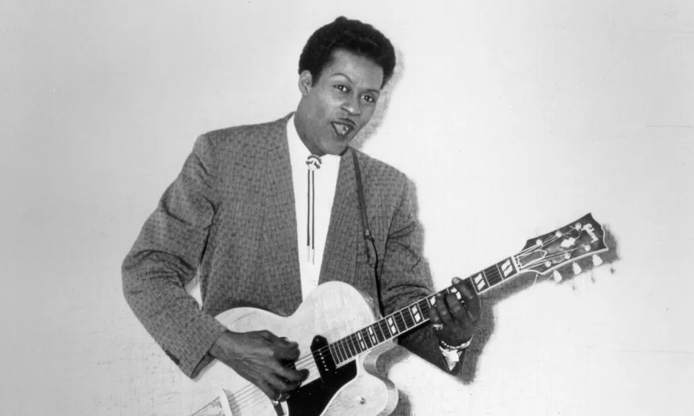 Chuck Berry on stage, guitar in hand, a pioneer of rock and roll and master of pop-culture storytelling.