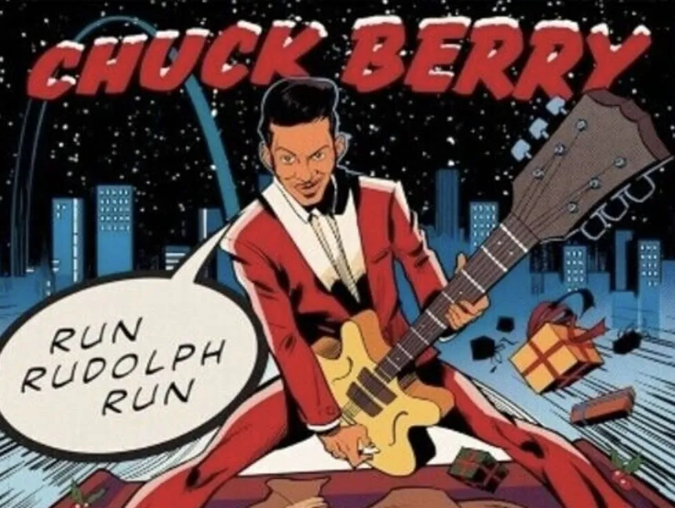 Chuck Berry performing with his signature electric guitar on stage, bathed in stage lights