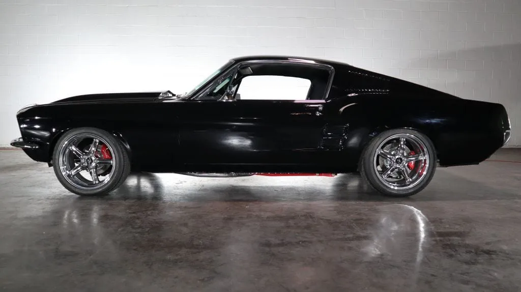 Classic American muscle cars lined up for sale at a dealership