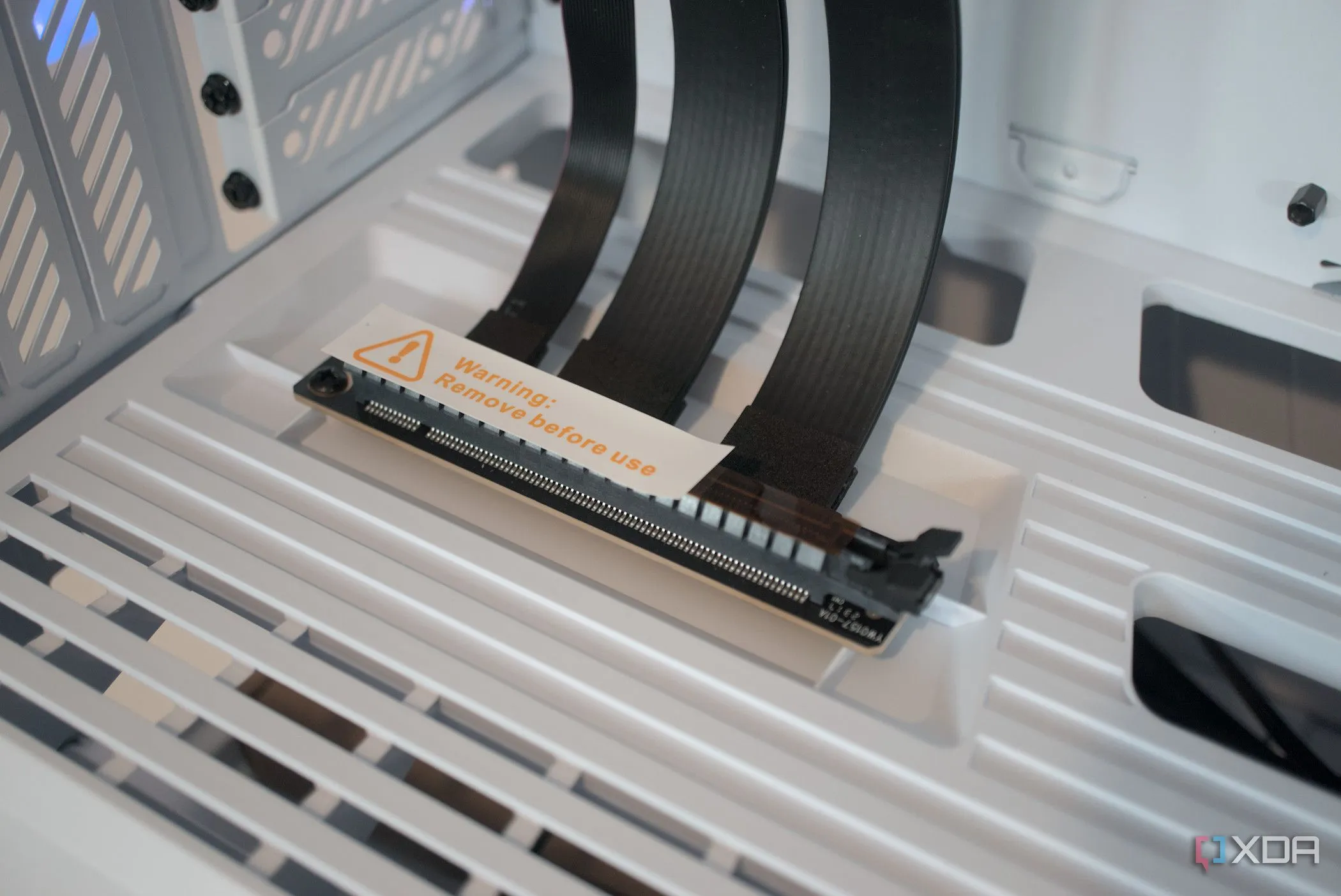 Close-up of a HYTE Y40 Snow White Edition case showing the PCIe riser slot