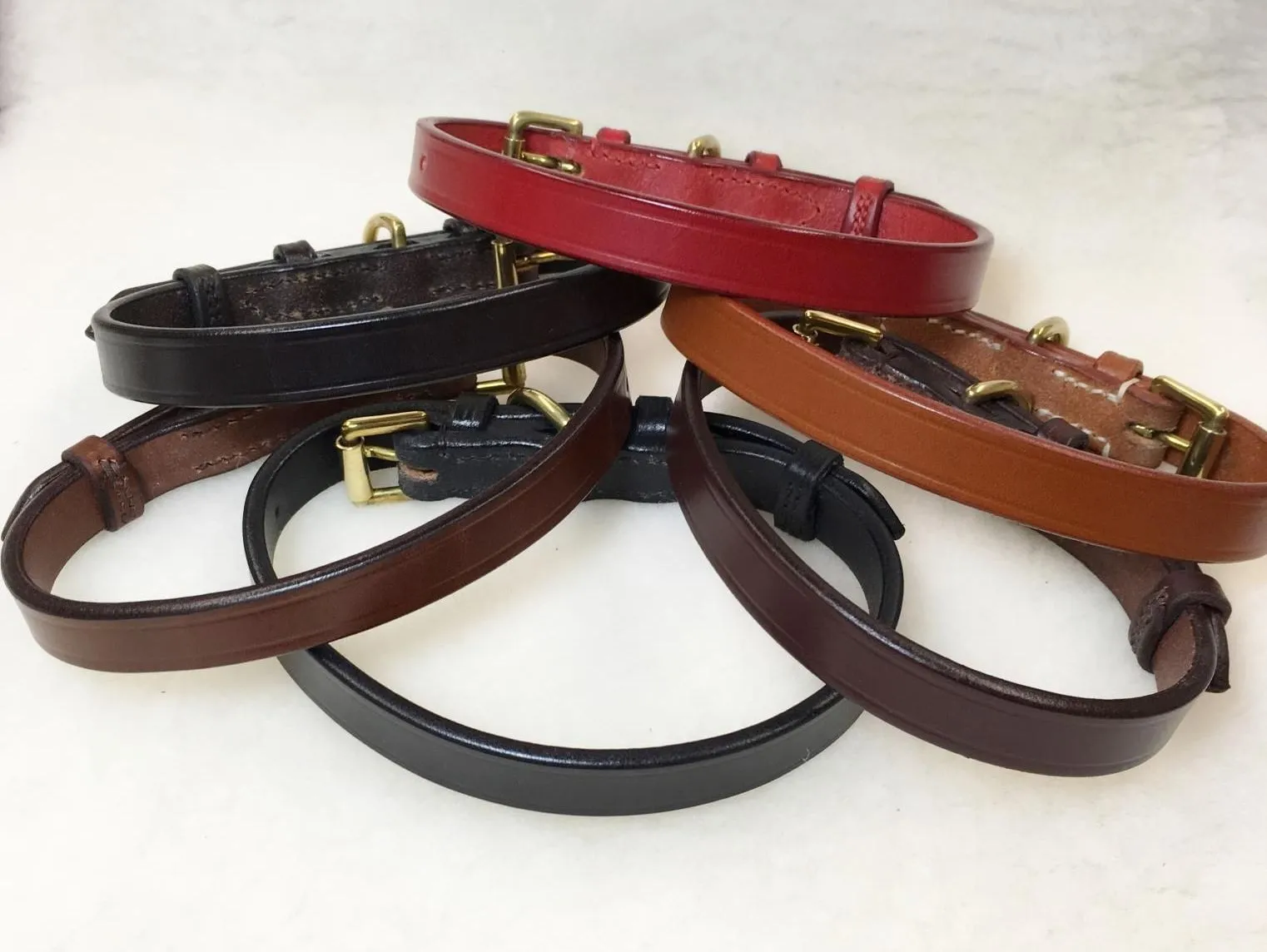 Close-up of a plain English bridle leather collar showing the stitching and buckle