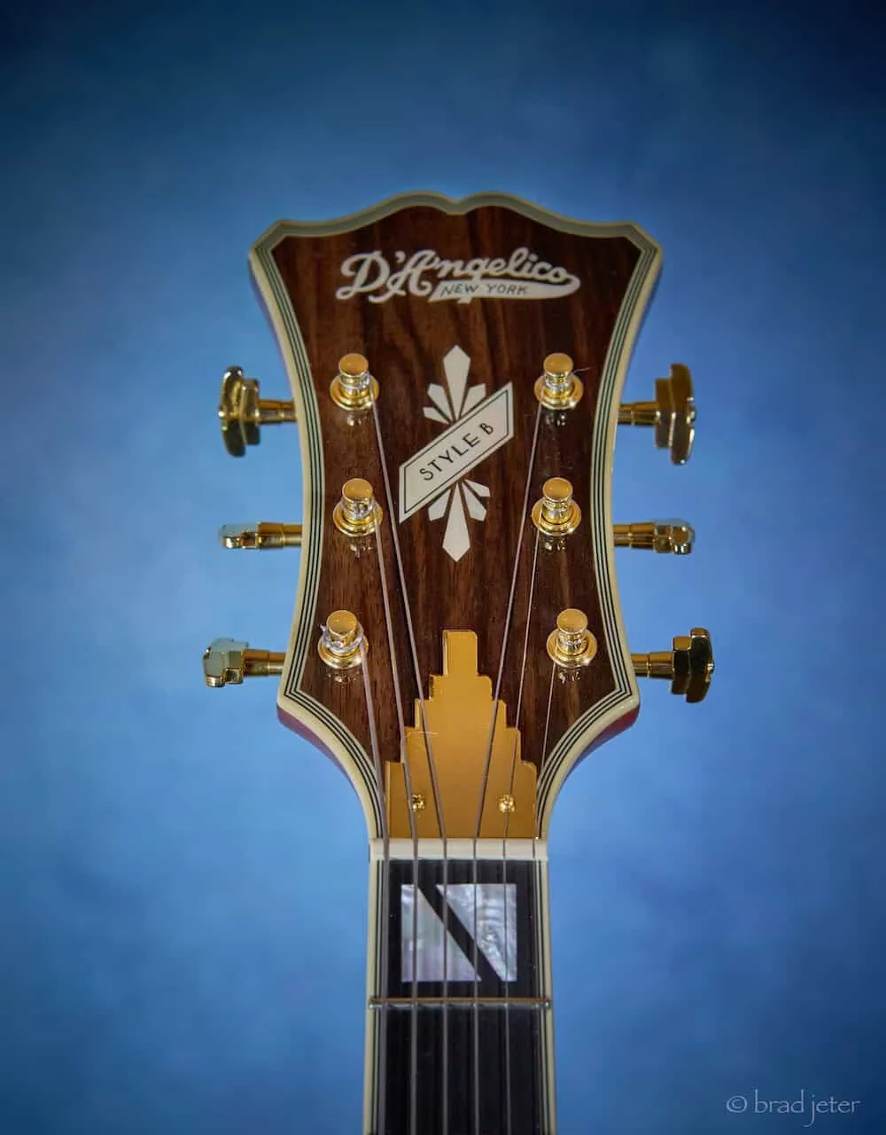 Close up of D'Angelico Excel Style B headstock showing Grover Imperial tuners and mother-of-pearl inlays