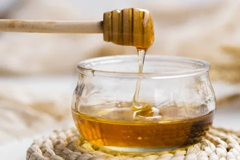 Close-up of natural honey pouring into a bowl