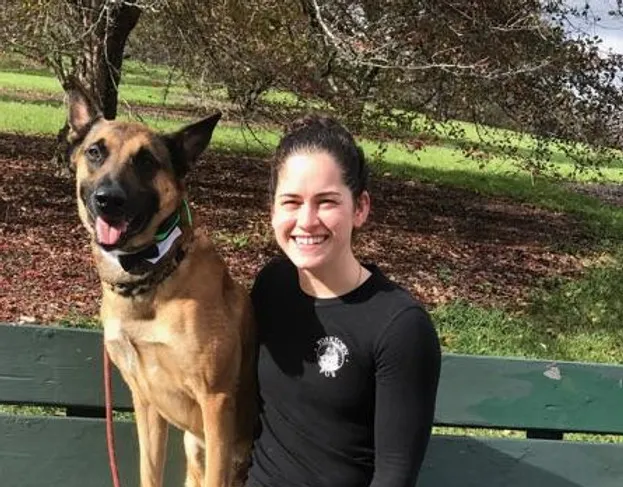 Danielle Smith smiling with a dog