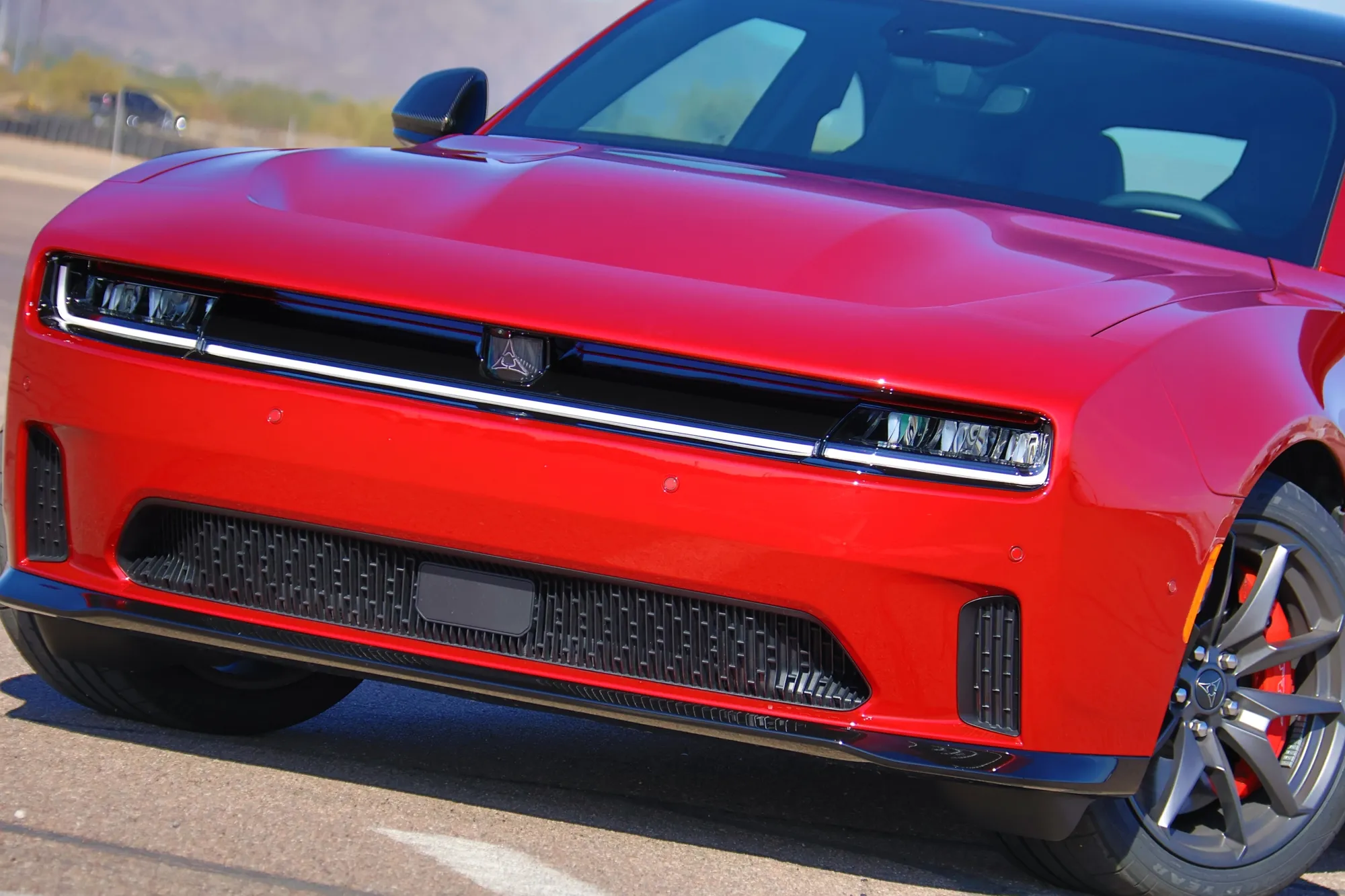 Detail shot of the 2024 Dodge Charger Daytona's unique R-Wing design and front lighting