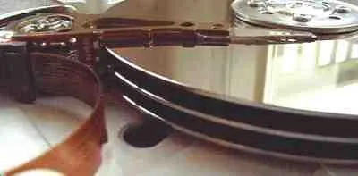 Detailed view of hard drive platters and read/write heads inside an opened hard disk