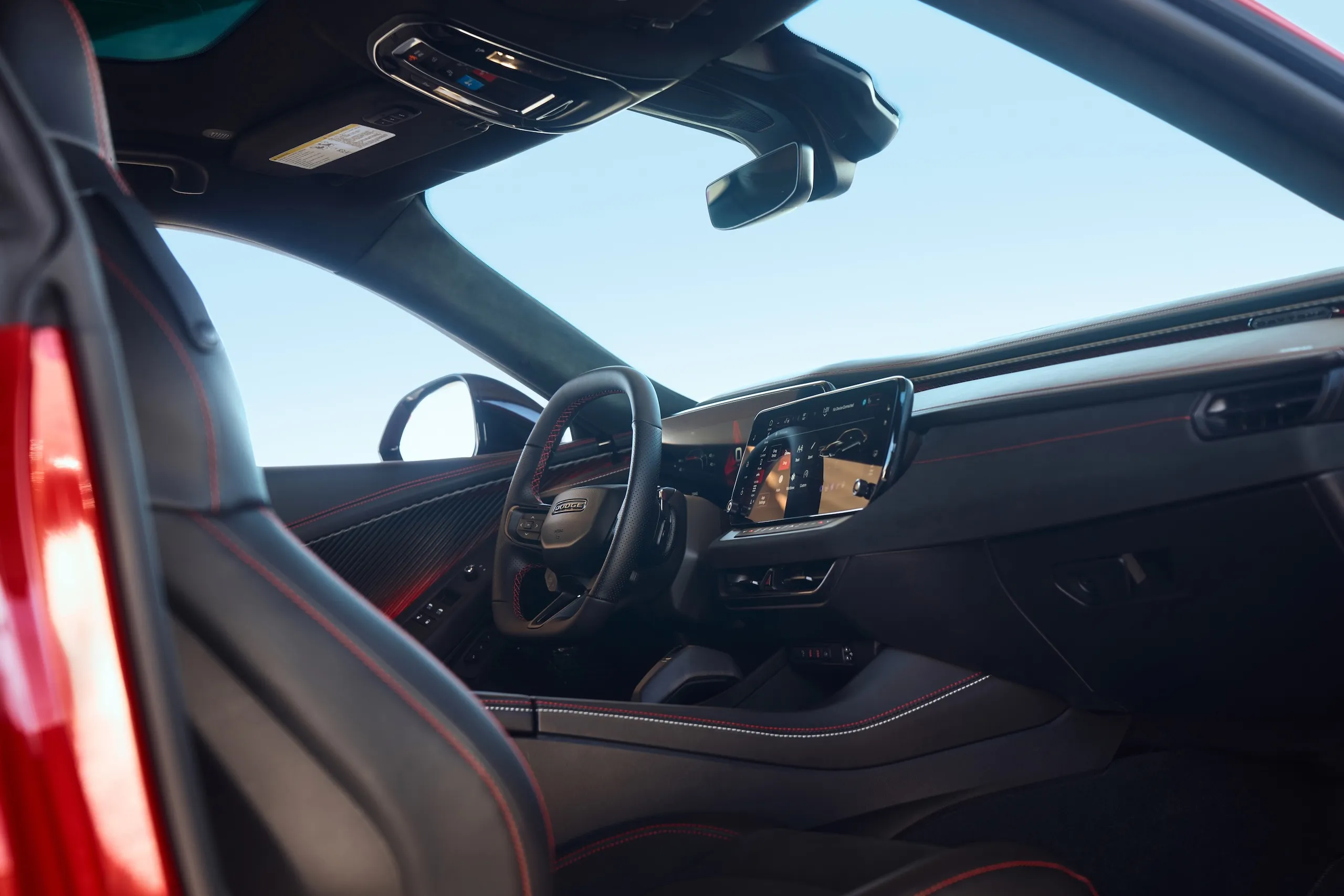 Detailed view of the 2024 Dodge Charger Daytona Scat Pack interior, highlighting screens and performance seats