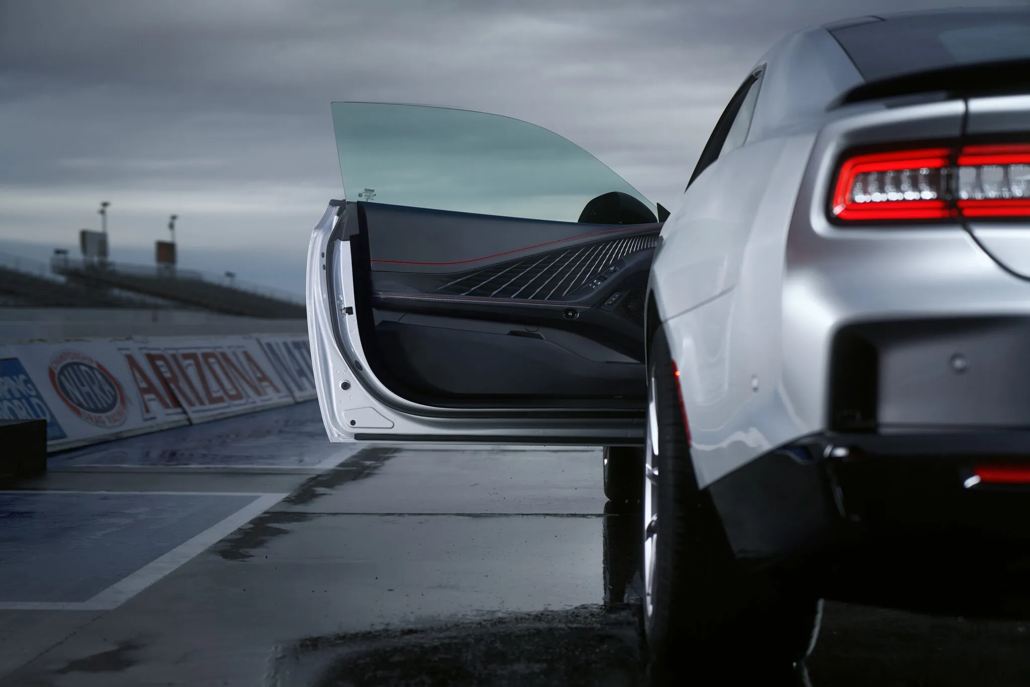 Dodge Charger Daytona Scat Pack accelerating on a race track, demonstrating its electric performance