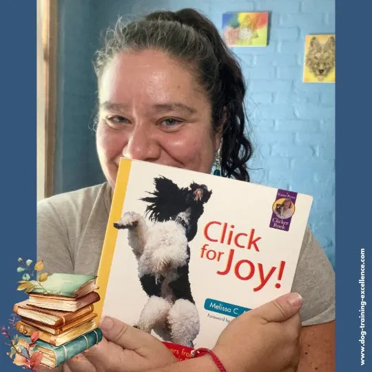 Dog training book "Click for Joy" cover showing a dog's smiling face