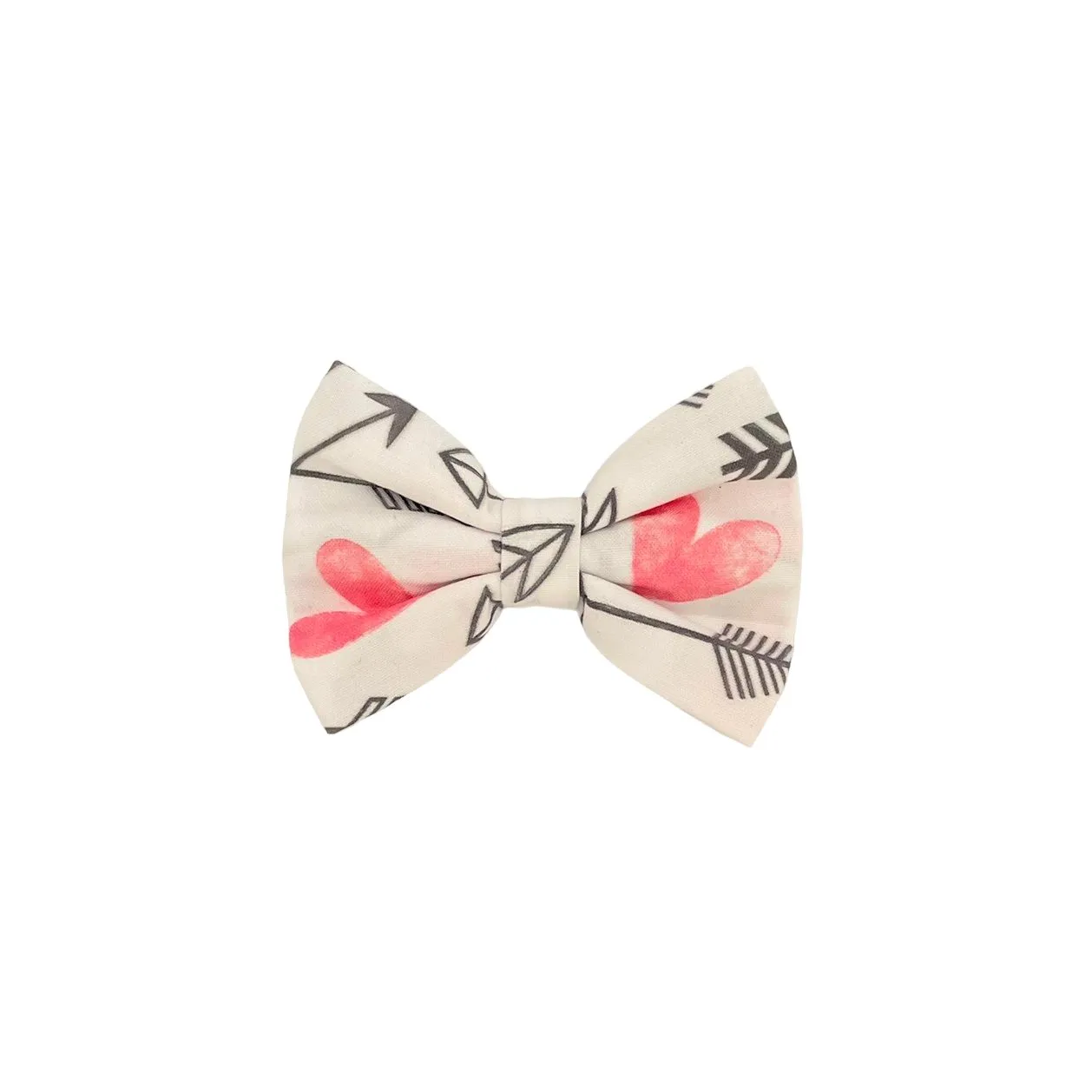 Dog wearing a bow tie with small arrow heart patterns, looking to the side.