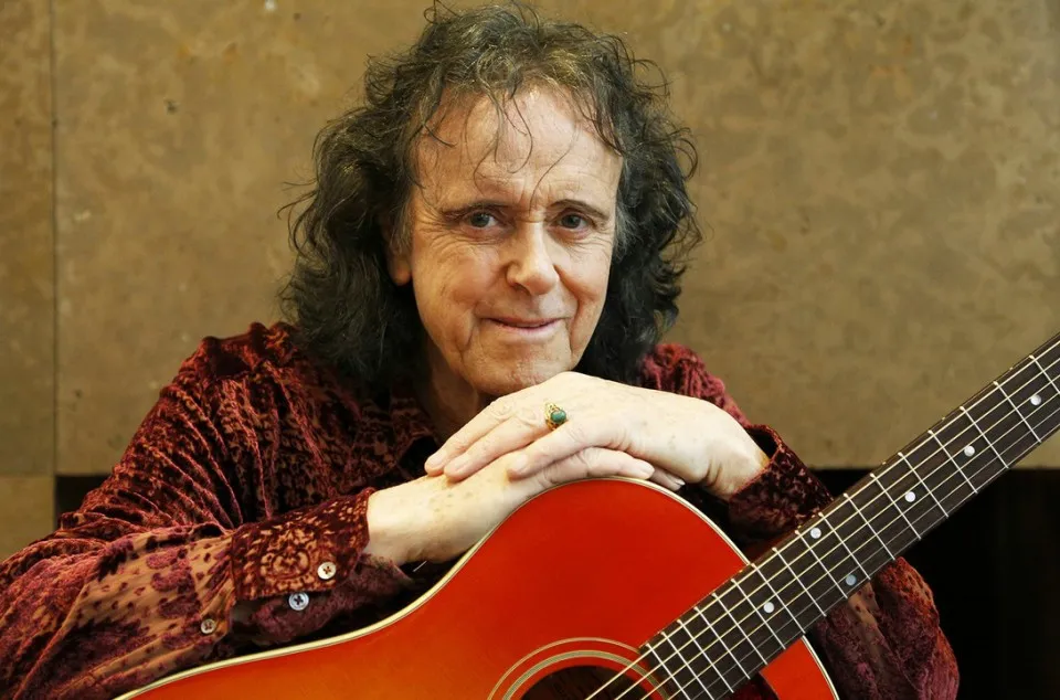 Donovan performing on stage in 2016, showcasing his enduring presence in music.
