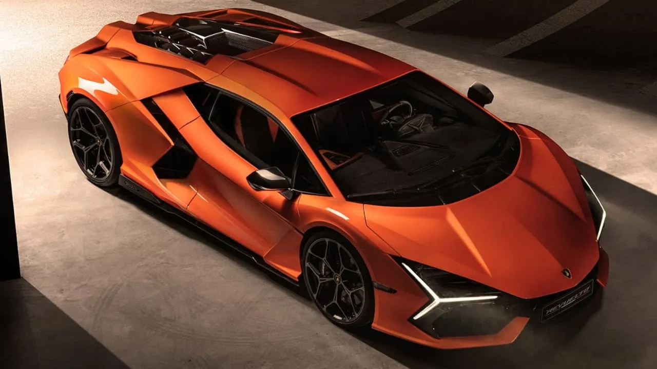 Dramatic side view of the Lamborghini Revuelto in vibrant orange, showcasing its angular design