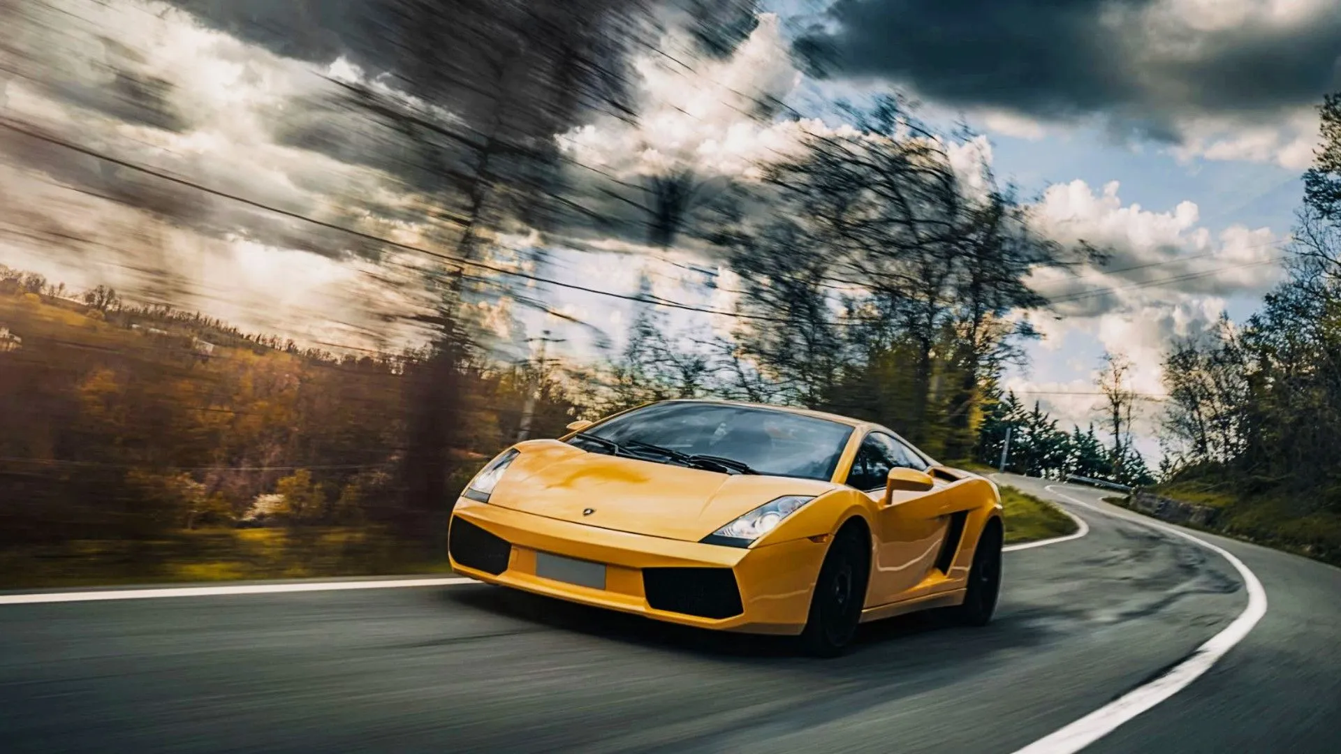 Dynamic action shot of a 2006 Lamborghini Gallardo coupe on the road