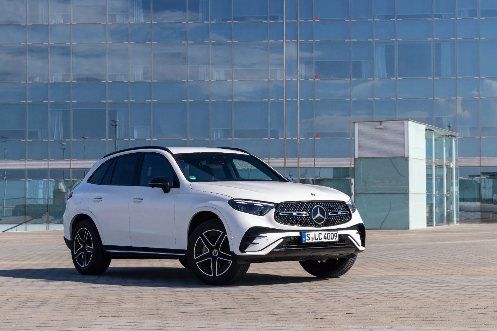 Dynamic front three-quarter view of a dark blue Mercedes-Benz GLC luxury compact SUV