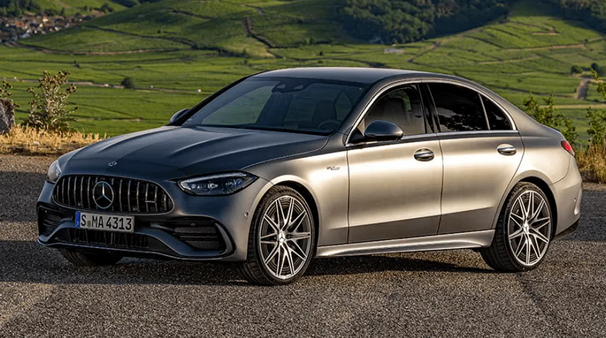 Elegant front-quarter view of the 2024 Mercedes-Benz C-Class sedan, parked outdoors.