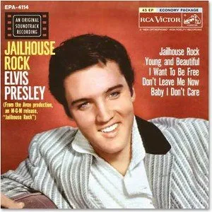 Elvis Presley holding a teddy bear during a performance, highlighting the popularity of his song "Teddy Bear."