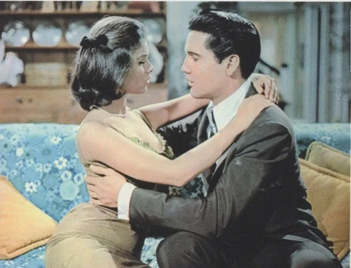 Elvis Presley interacting with a child during the filming of "It Happened At The World's Fair" at the Seattle World's Fair