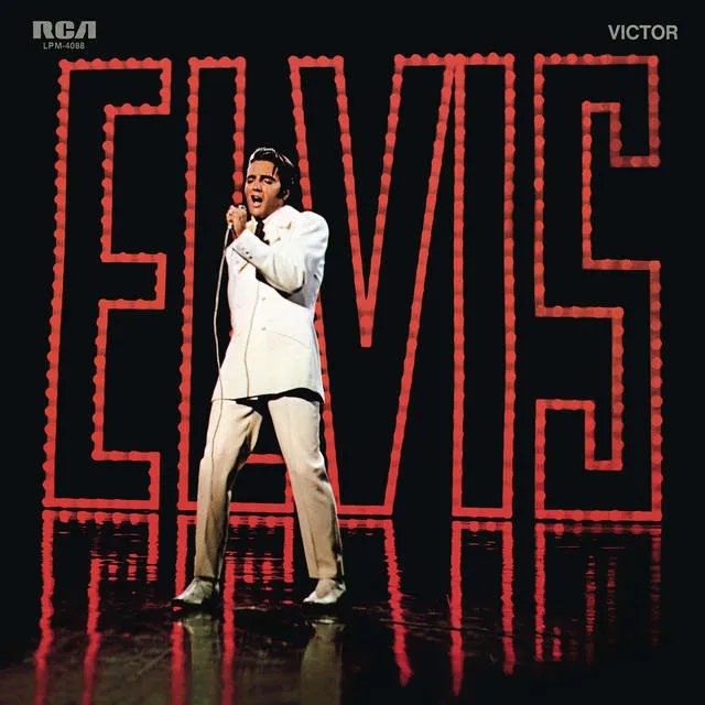 Elvis Presley performing live on stage during his '68 Comeback Special, captivating the audience with his powerful presence and signature style.