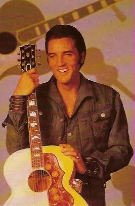 Elvis Presley performing on stage in a glittering jumpsuit, captured during a live concert.
