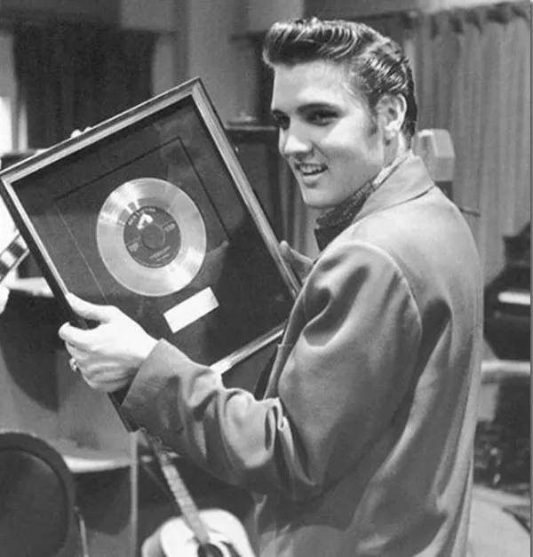 Elvis Presley performing with intense emotion, capturing the despair of Heartbreak Hotel