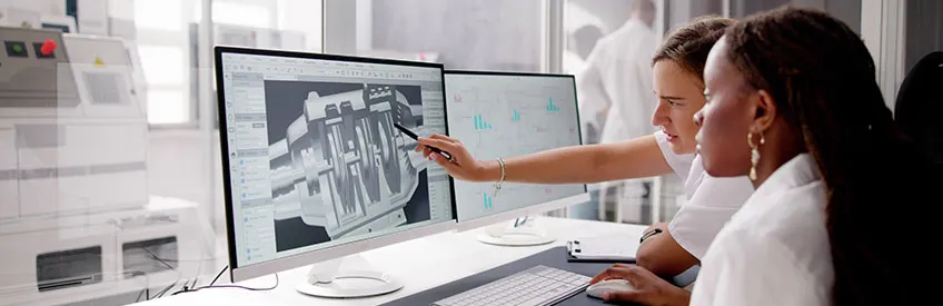 Engineer designing a 3D CAD model on a computer at a factory
