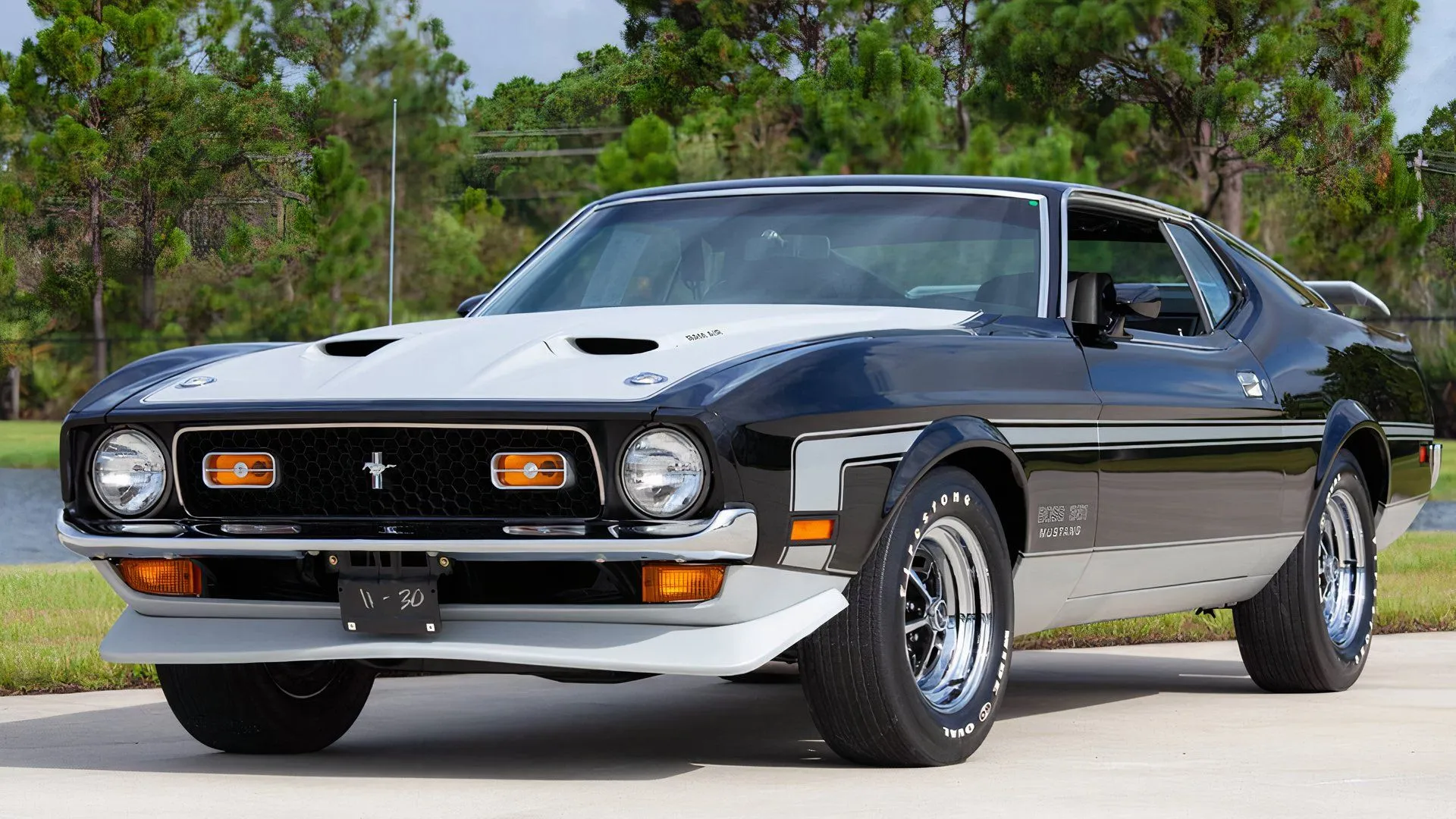 Front 3/4 view of a green 1971 Ford Mustang Boss 351 parked outdoors