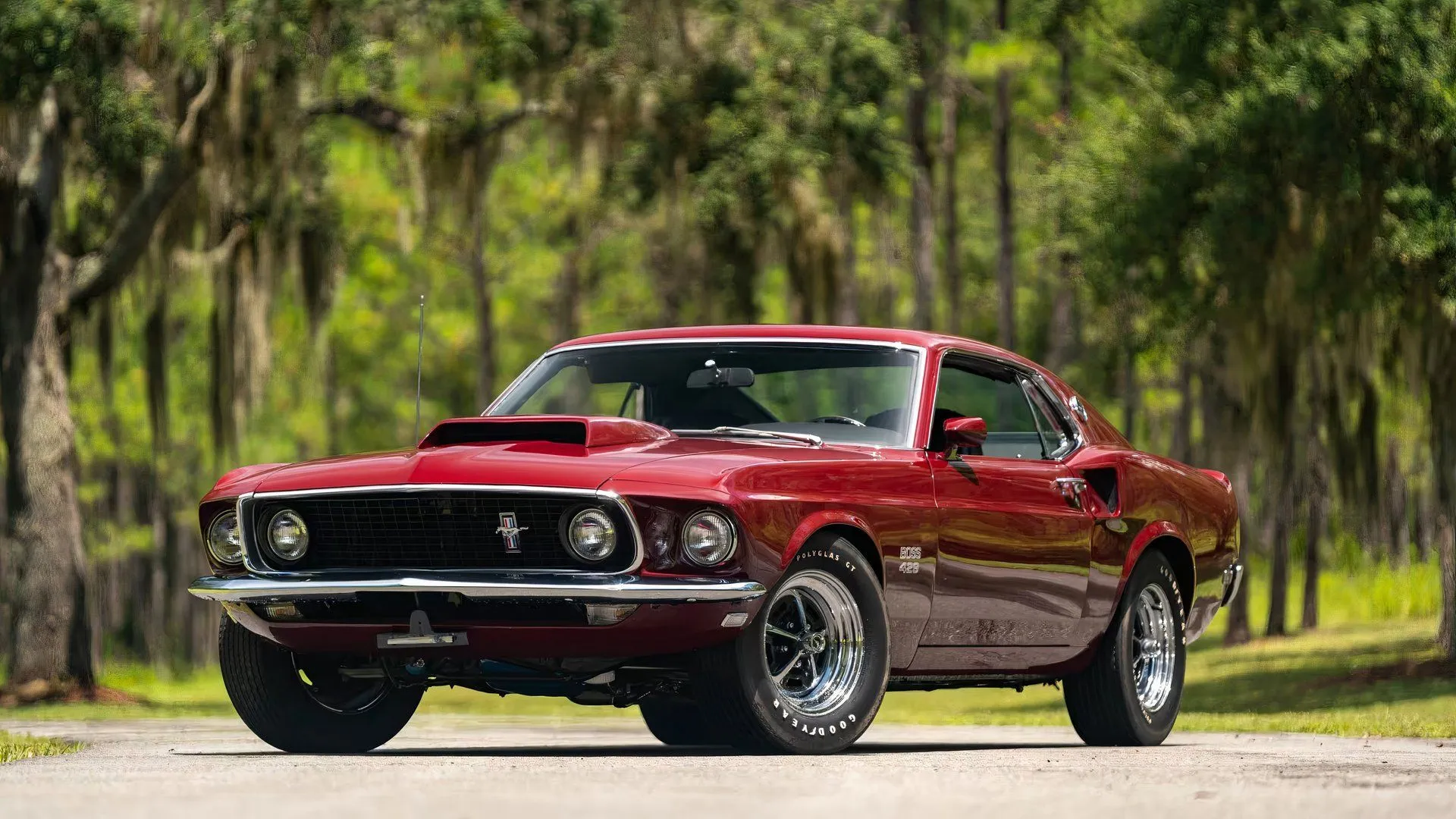 Front 3/4 view of a powerful 1969 Ford Mustang Boss 429 Fastback in dark blue