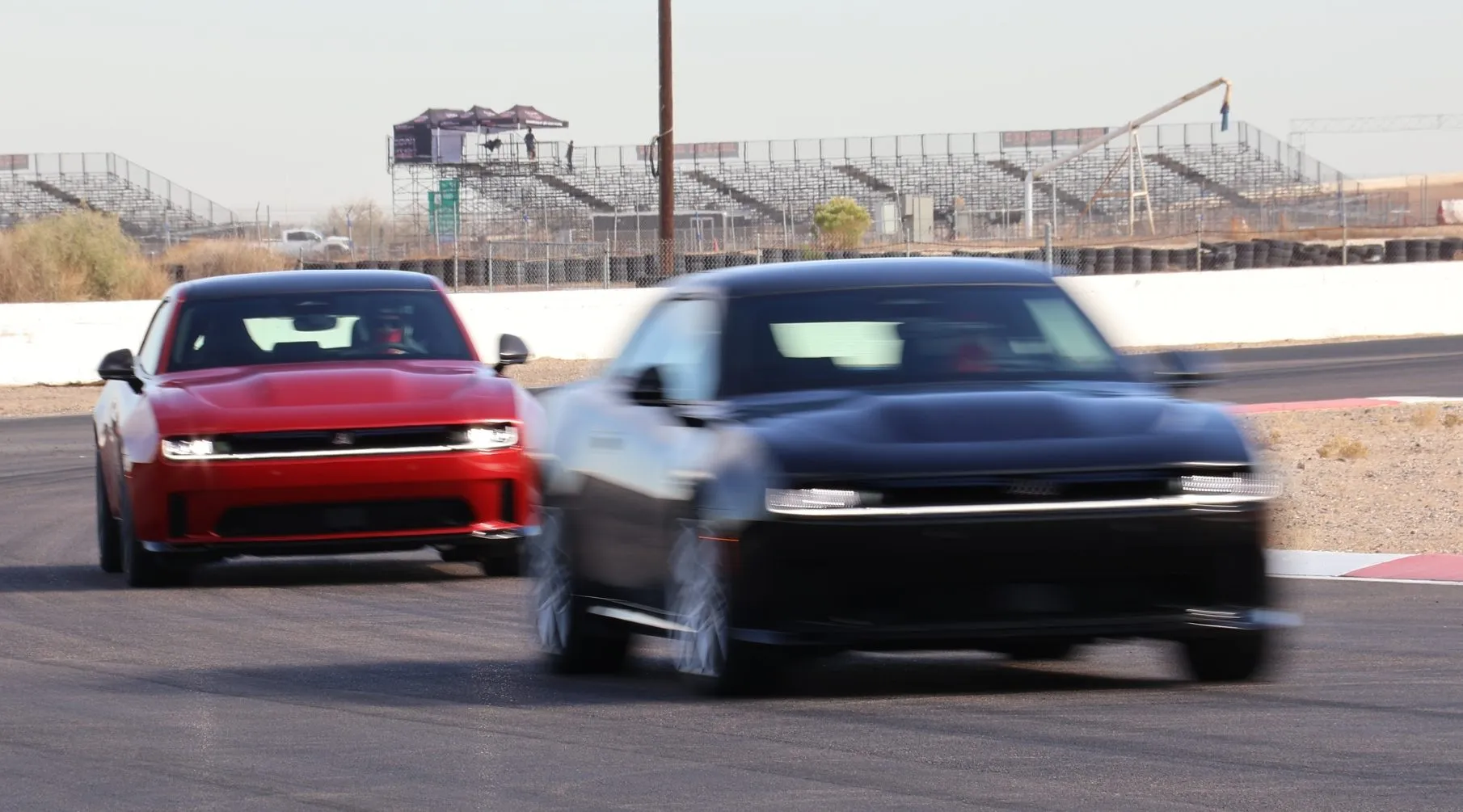 Front three-quarter view of the 2024 Dodge Charger Daytona on a track, turning into a corner