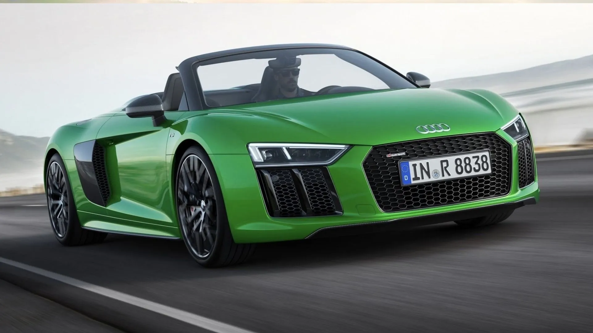 Green 2018 Audi R8 Spyder V10 Plus posing on a coastal road