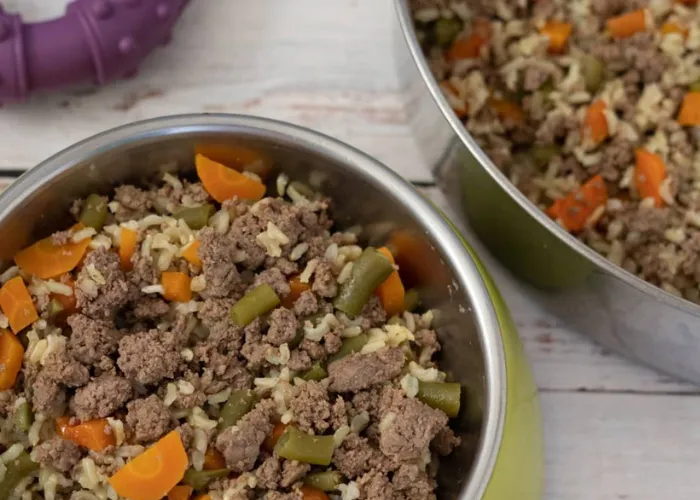 Ground lamb, cooked lentils, pureed sweet potatoes, and chopped zucchini in a saucepan
