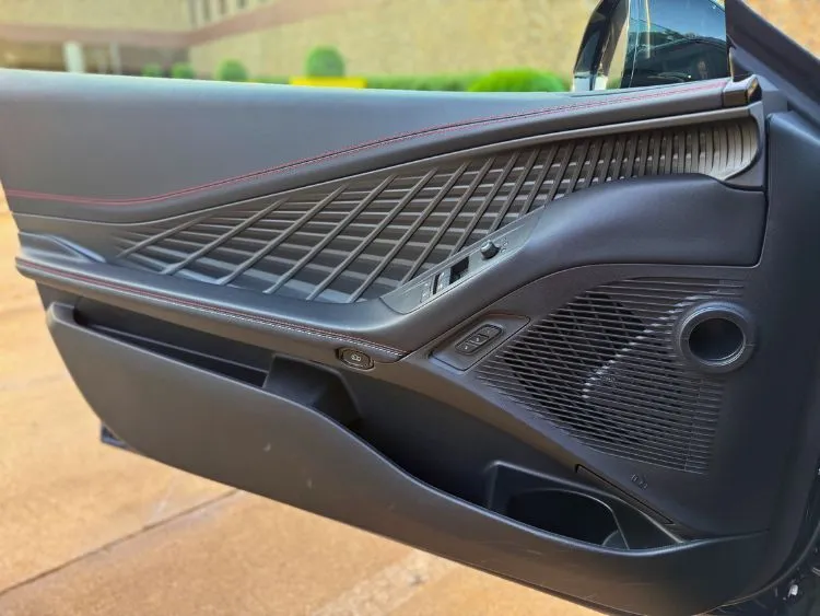 Illuminated door panel in the 2024 Dodge Charger Daytona R/T Plus at night with ambient lighting