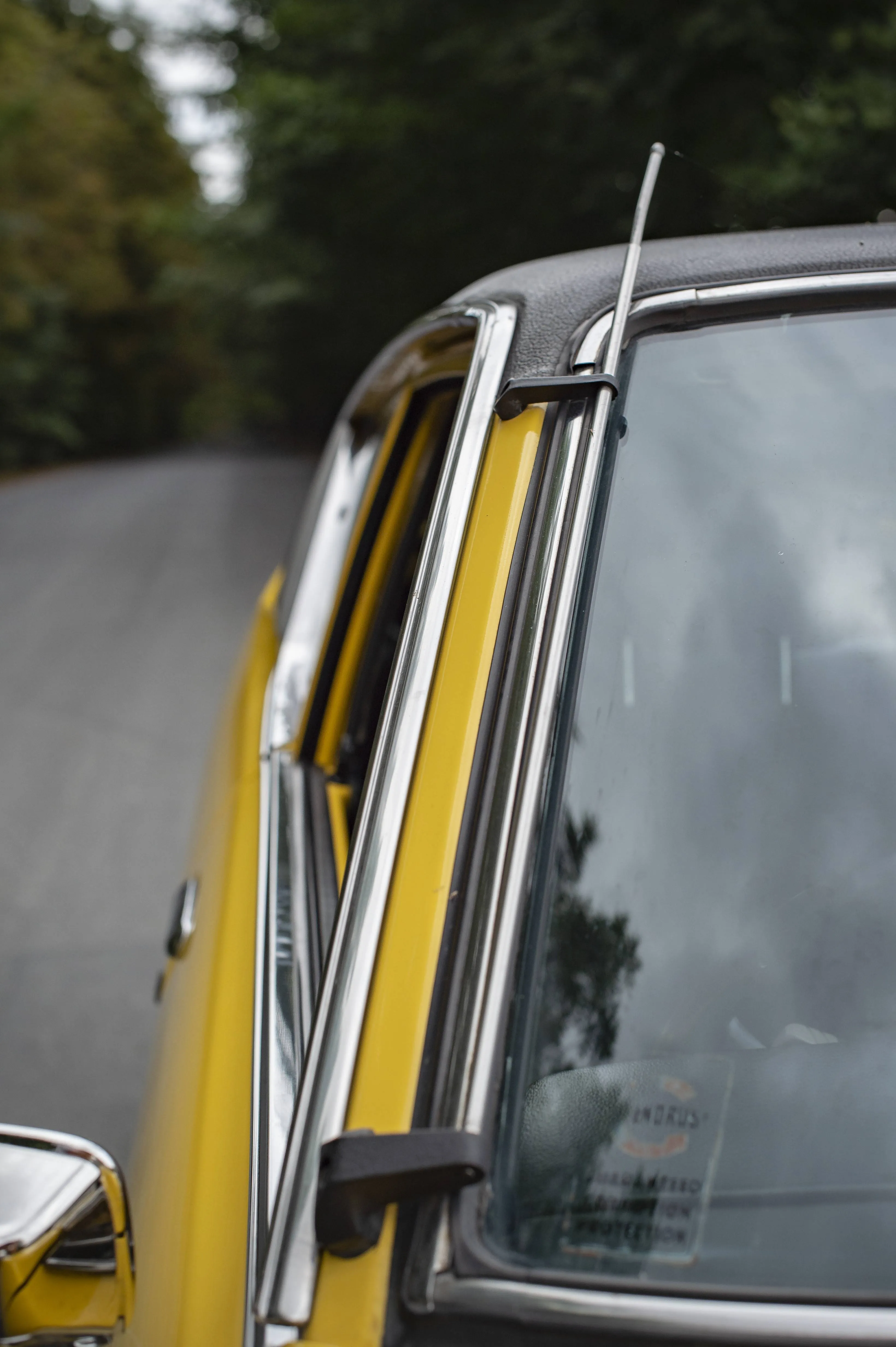 Interior view of a 1978 Datsun 120Y coupe, showing original seats and dashboard