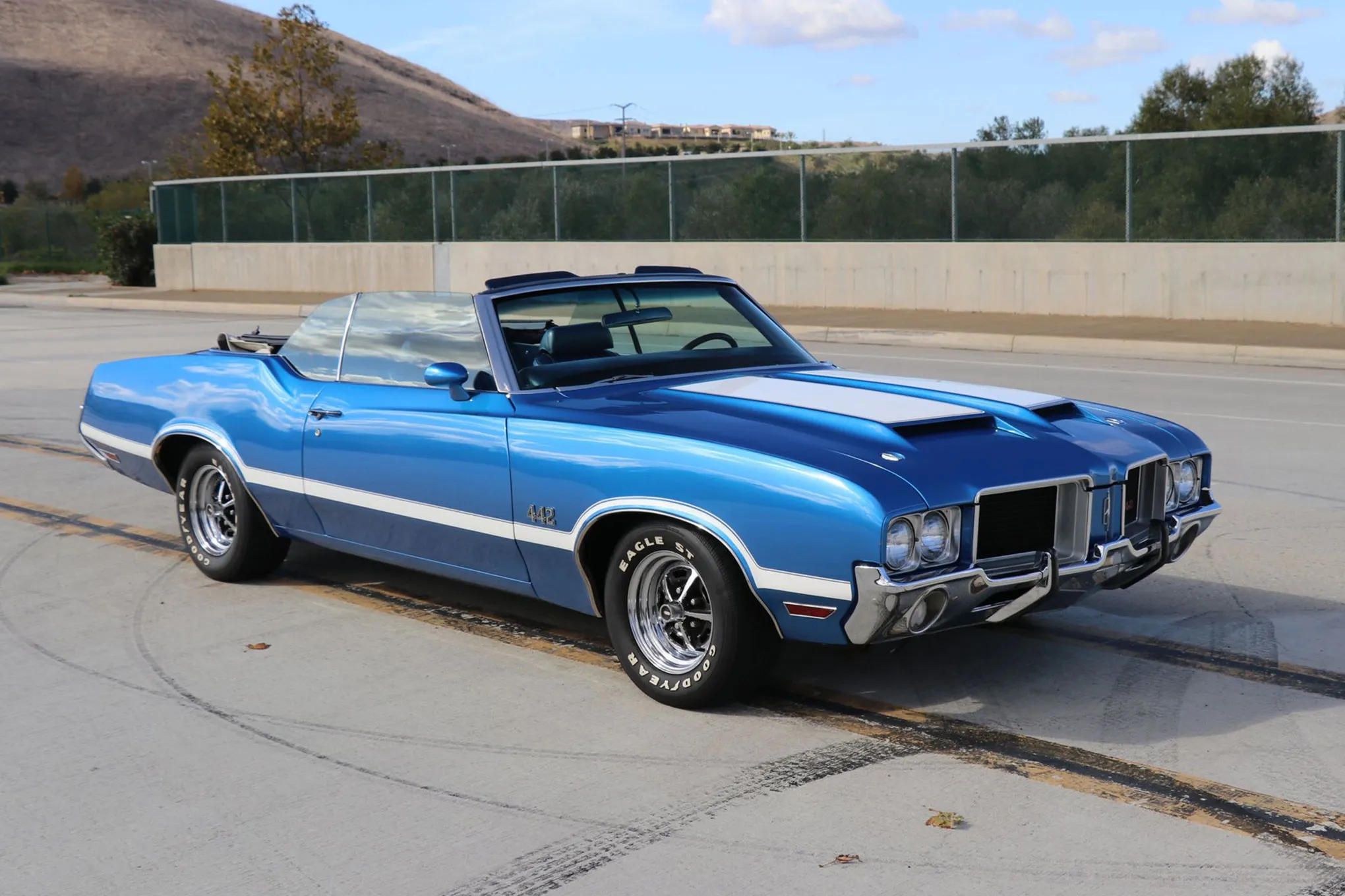 Interior view of a blue and white 1971 Oldsmobile 442 Convertible showing the dashboard and seating