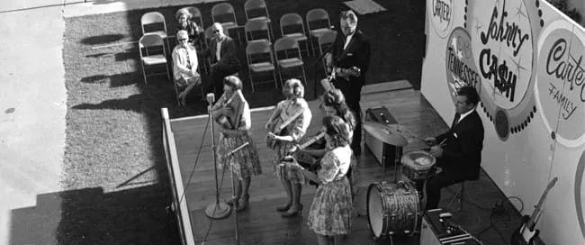 Johnny Cash and The Carter Family on stage, a group photo including Maybelle, June, Helen, and Anita Carter.