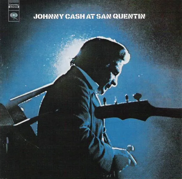Johnny Cash on stage, defiantly performing for the inmates at San Quentin Prison.