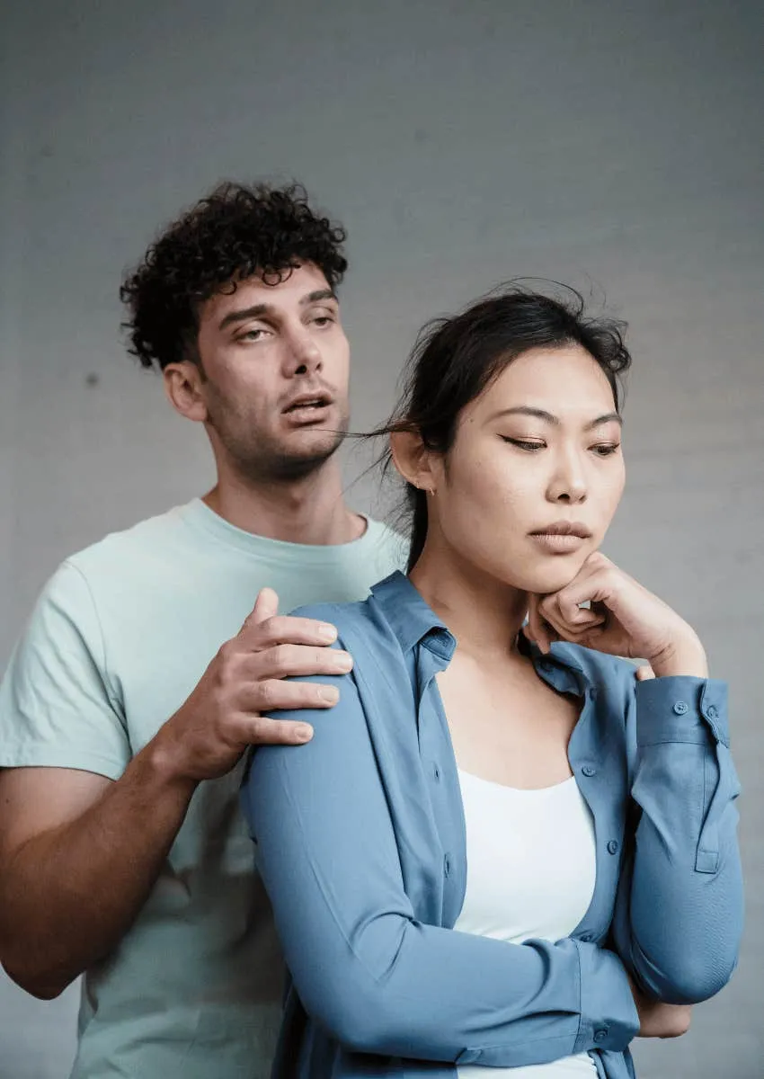 man trying to comfort an upset woman