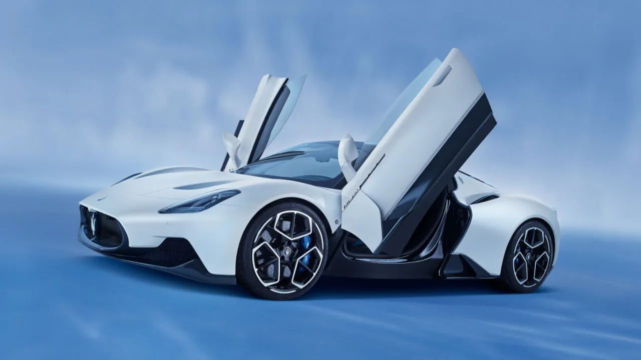 Maserati MC20 in a striking white, with its unique butterfly doors open